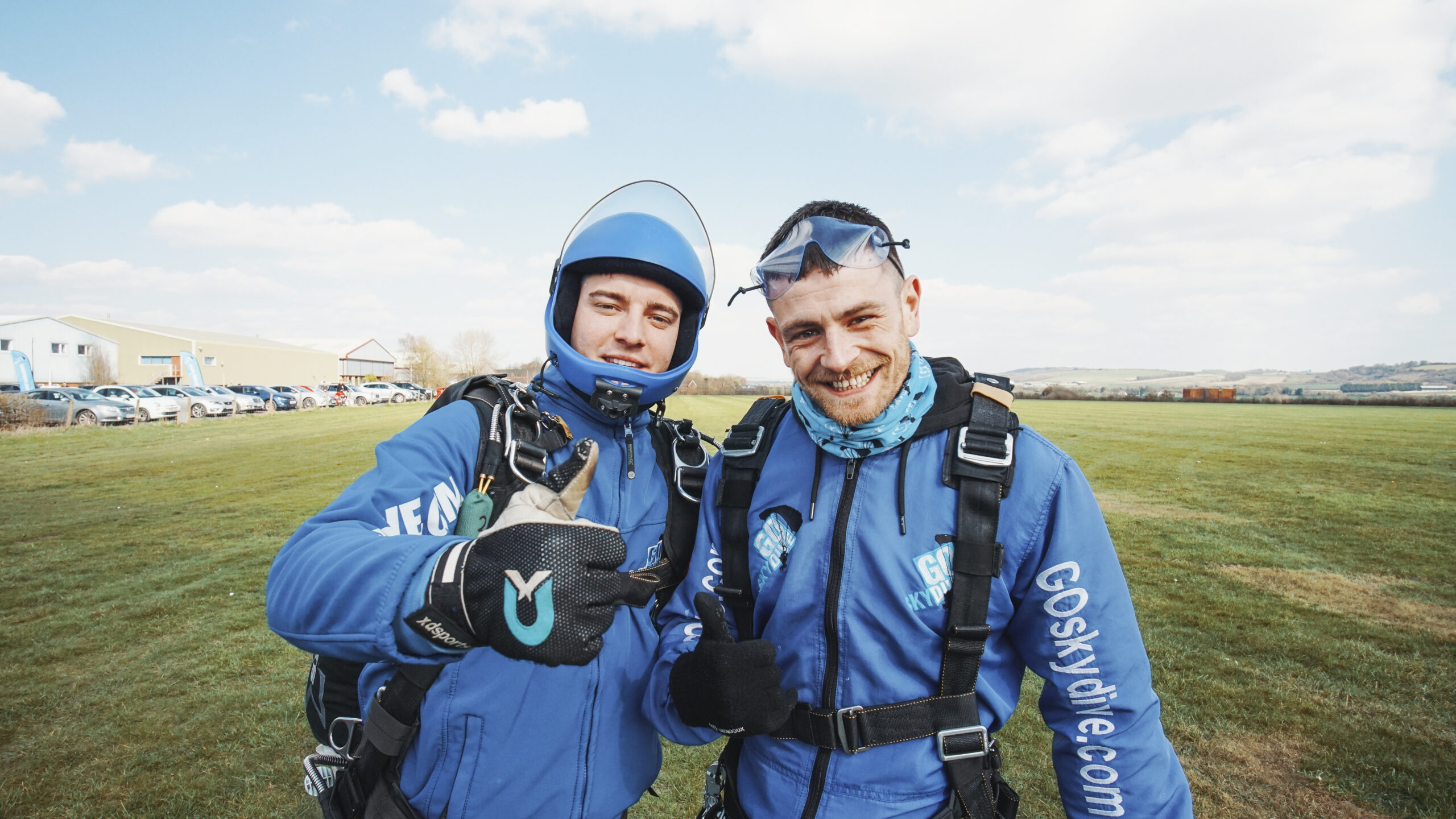 Tandem Skydive instructor with thumbs up and customer