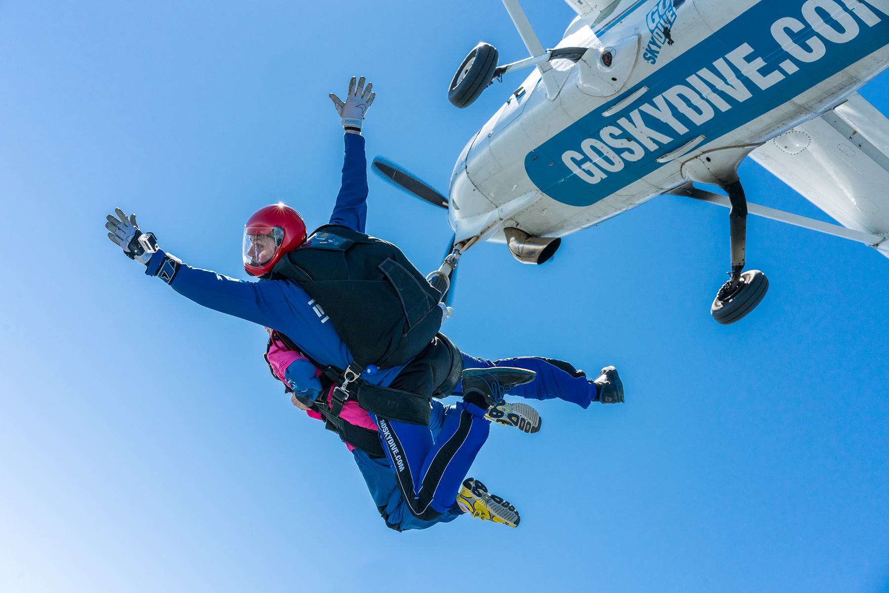 Tandem Skydiver falling from aeroplane in sunshine