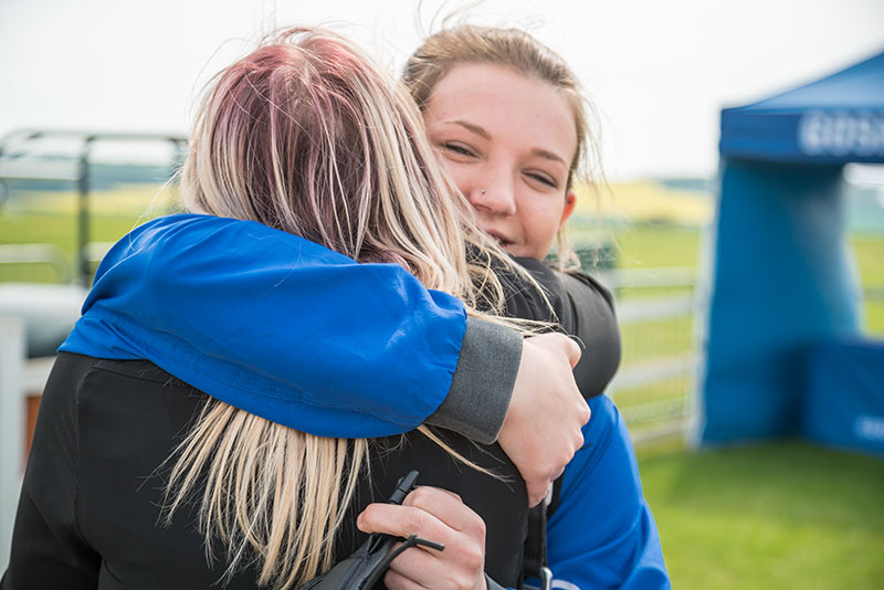 Customers hugging at GoSkydive having completed their jump